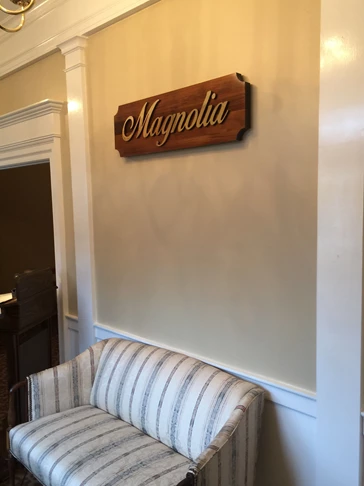 Dimensional polished brass lettering on magnolia for a funeral home in Marietta